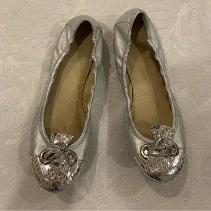Silver ballerina flats.